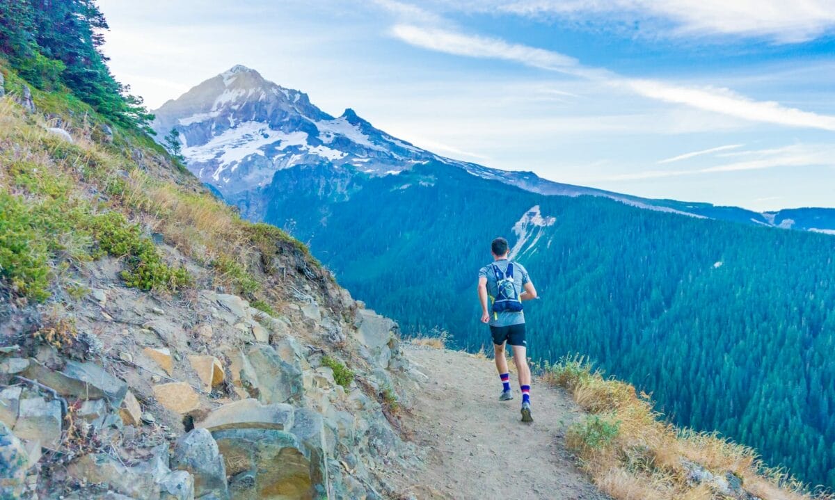 photo of a man trail running