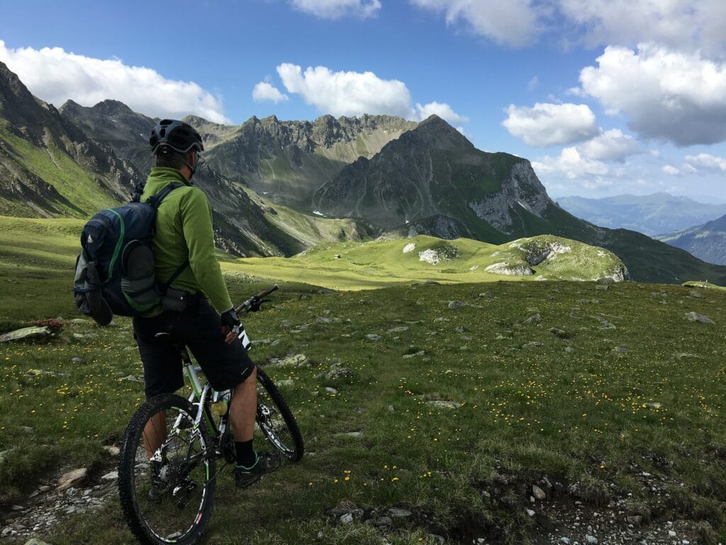 image of a man mountain biking in the Alps